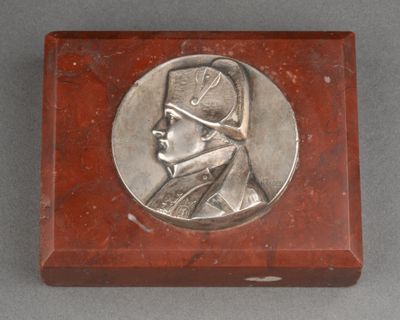 an image of a silver medallion of a man in a military uniform