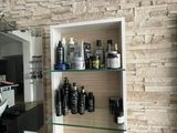 une salle de bains avec un mur en briques et un miroir au-dessus