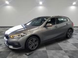 a silver bmw 216i sport wagon parked in a showroom