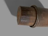 a close up of a pipe with a wooden handle