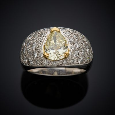 a close up of a diamond ring on a black surface