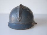 a blue helmet on a white table with a white wall in the background