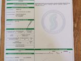 two papers on a wooden table with a barcode on top of them