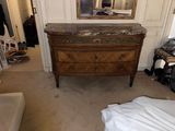 an image of a bedroom with a dresser and a mirror
