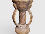 an old wooden vase sitting on top of a white surface