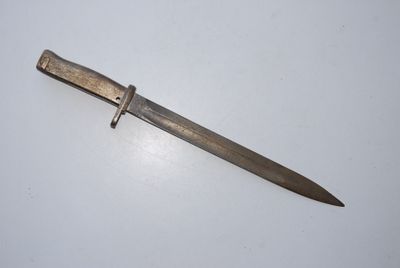 an old knife on a white surface with a metal handle