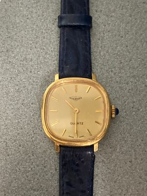 an image of a close up of a wrist watch on a table