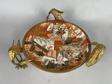 a decorative plate with a bird on top of it