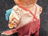 a teddy bear that is standing on a small box