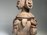 a close up of a clay figurine with a face on it