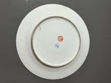 an image of a white plate with a red and blue design on it