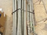 a lot of pipes sitting on the floor in a warehouse