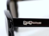 sunglasses with black frames and a silver logo on the side of the glasses