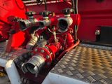 a red fire hydrant sitting on the back of a truck