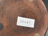 a close up of a brown vase with numbers on it