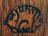 a wooden door with a sign on it with a picture of a cat