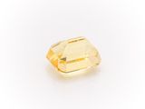 a yellow sapphire stone on a white background