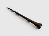 a close up of a clarinet on a white surface with a white background