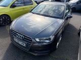 a black audi parked in a parking lot next to other cars