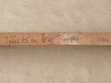 a baseball bat with writing on it on a table