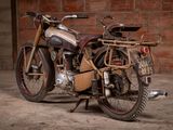 a old motorcycle that is parked in front of a brick wall