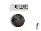 a small coin with a barcode on the side of it