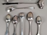 a lot of silver spoons and spoon spoons on a table