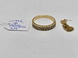 a gold ring with a chain attached to it next to a tag