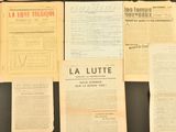 many old french newspapers on a black table