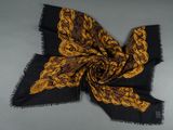 a black and yellow scarf with a paisley design
