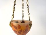 a close up of a light fixture hanging from a chain