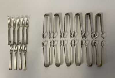 a lot of forks and spoons that are on the table