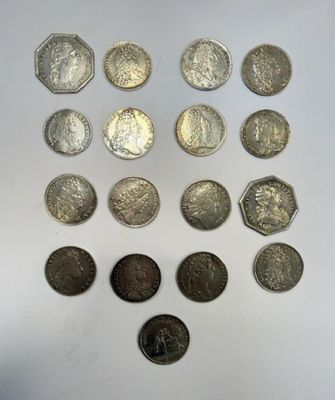 a bunch of coins sitting on top of a table next to each other