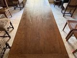 a long table in the middle of a room with many chairs