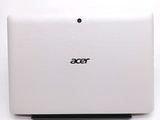 the back of a white laptop computer sitting on top of a white table