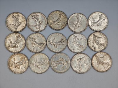 a bunch of silver coins sitting on top of a white surface