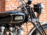 a black and gold motorcycle parked in front of a brick wall