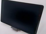 the back of a black tablet computer sitting on top of a white table