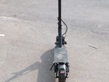 a scooter that is sitting on the ground in the parking lot
