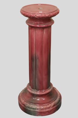 a red pedestal with a red top on a gray background