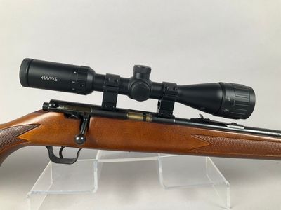 a rifle with a scope mounted on top of it