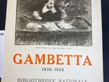 an old poster of a woman reading a book on a table