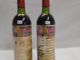 two bottles of wine sitting next to each other on a table