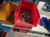 a red container with nuts and nuts in it sitting on a table