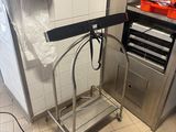 a metal cart that is sitting in a kitchen