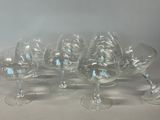 several empty wine glasses are lined up on a table