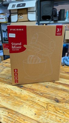 a cardboard box on a table with a mixer in it