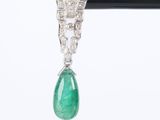 a close up of a pair of emerald and diamond earrings