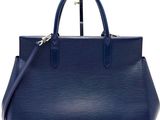 a blue louis vuitton bag on a white background