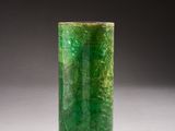 an image of a green vase sitting on top of a white table